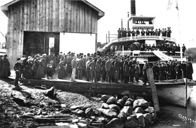 Passengers arrive and disembark on the riverboat City of Salem someplace on the mid-Willamette River. One of the silhouettes in the wheelhouse is almost certainly Capt. Scott.